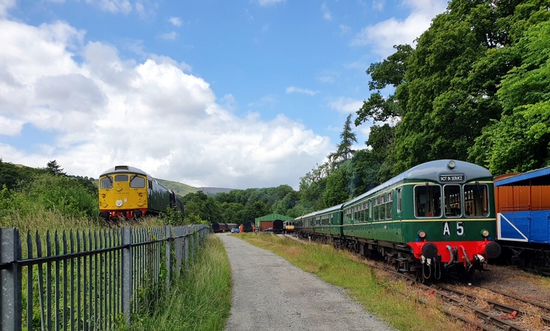 Class 26 D5310 passing 4-car Class 109 and class 108 at Pentrefelin depot on 12/06/22