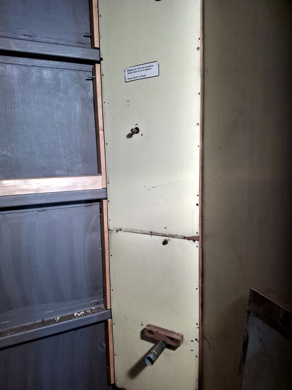 Class 105: Trial-fitting some of the original panelling in the toilet cubicle